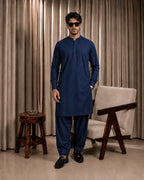 Man in navy blue unstitched suiting fabric kurta and shalwar, formal men's wear for festive or business occasions