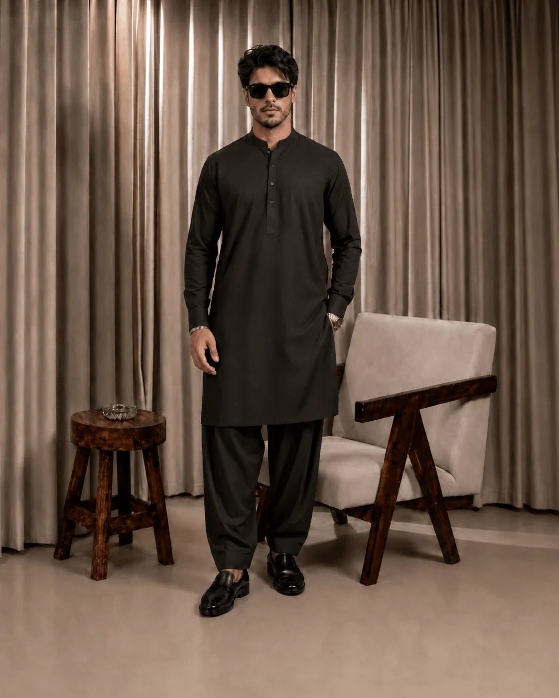 Man in black unstitched suiting fabric kurta and trousers for formal wear