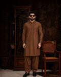 Men's brown unstitched suiting fabric for formal wear, styled with matching shalwar and black loafers