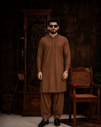 Men's brown unstitched suiting fabric for formal wear, styled with matching shalwar and black loafers