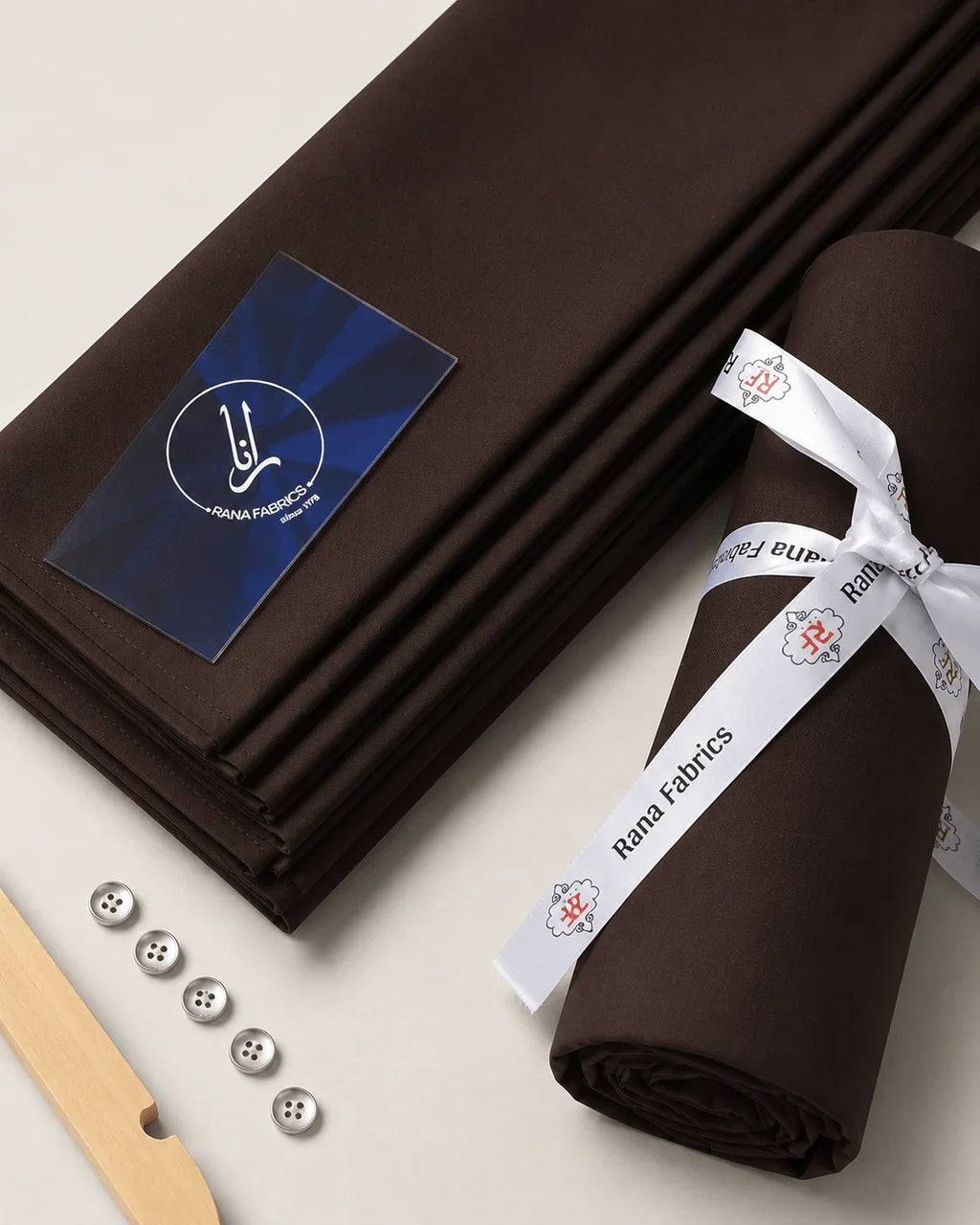 Premium brown men's suiting fabric, neatly folded and rolled with Rana Fabrics ribbon, ideal for formal wear.