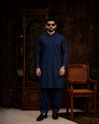 Man in navy blue unstitched suiting fabric kurta and shalwar, ideal for formal or festive wear