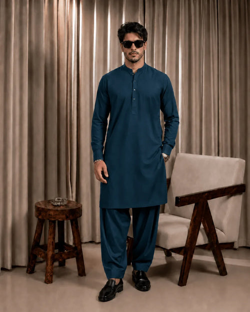 Man in teal unstitched suiting fabric kurta and shalwar, ideal for formal or festive wear