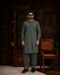 Men's olive green unstitched suiting fabric for formal and festive wear, paired with matching trousers.