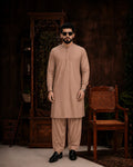 Man in beige unstitched suiting fabric kurta and shalwar, ideal for formal and festive wear
